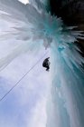 Young man ice-climbing in Banff National Park near Banff, Alberta, Canada. — Stock Photo