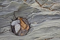 Natural pattern of eroded rock face on river bank, full frame. — Stock Photo