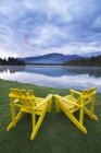 Lawn chairs on shore of Lac Beauvert, Jasper National Park, Alberta, Canada — Stock Photo