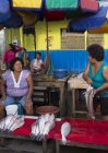 Women at fish stall in market scene of Iquitos in Peru — Stock Photo