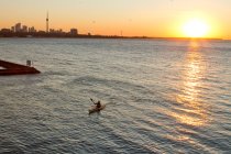 Young man paddling kayak on Lake Ontario at entrance to Humber River, Toronto, Ontario, Canada. — Stock Photo