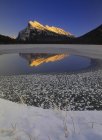 Vermilion Lakes water reflecting Mount Rundle in sunlight in winter, Banff National Park, Alberta, Canada. — Stock Photo