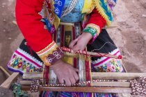 Primer plano de la mujer local realizando tejido tradicional, Pisac, Perú - foto de stock