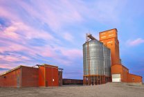 Grain elevator and silos at sunset in Morse, Saskatchewan, Canada. — Stock Photo