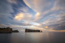 Perce Rock in water at sunset in Gaspesie, Quebec, Canada. — Stock Photo