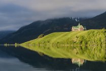 Prince of Wales Hotel reflecting in water of Waterton Lakes National Park, Alberta, Canada — Stock Photo