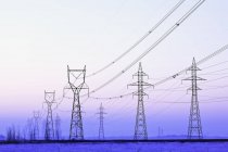 Power transmission towers at dusk near Winnipeg, Manitoba, Canada. — Stock Photo