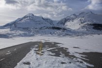Deserted snow-covered highway into Athabasca Glacier, Jasper National Park, Alberta, Canada. — Stock Photo