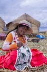 Местная жительница ползает в деревне камышового острова Урос, озеро Титикака, Перу — стоковое фото
