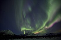 Aurora borealis above mountains outside of Whitehorse, Yukon, Canada. — Stock Photo