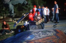 Skateboarder kickfliping board over pyramid in graffiti painted skatepark, Ladner, British Columbia, Canada. — Stock Photo