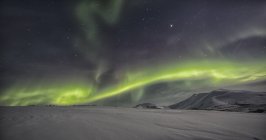 Northern lights above snow covered tundra along Dempster Highway, Yukon, Canada. — Stock Photo