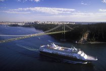 Aerial view of cruise ship passing under Lions Gate Bridge, Vancouver, British Columbia, Canada. — Stock Photo