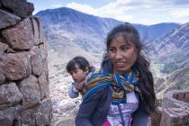 Einheimische Frau mit Tochter in traditioneller Kleidung auf der Straße des Dorfes Pisac, Peru — Stockfoto