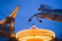 Eiffel Tower and spinning Carousel de la Tour at night, Paris, France. — Stock Photo