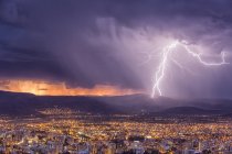 Rayo durante tormenta al atardecer sobre paisaje urbano de Cochabamba en Bolivia . - foto de stock