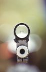 Rifle barrel aiming on blurred background — Stock Photo