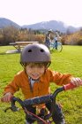 Boy biking with parents along trail near Meadow Park Recreation Centre in British Columbia, Canada — Stock Photo