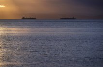 Freighters on water in Georgia Strait at sunset, British Columbia, Canada. — Stock Photo