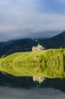 Prince of Wales Hotel reflecting in water of Waterton Lakes National Park, Alberta, Canada — Stock Photo
