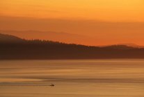 Рыболовный троллер на проливе Аро с многослойными холмами в Виктории, на острове Ванкувер, Британская Колумбия, Канада
. — стоковое фото