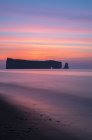 Perce Rock sheer rock formation in water before sunrise, Gaspesie, Quebec, Canada. — Stock Photo