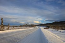 Snow covered Alaska Highway by Whitehorse, Yukon, Canada. — Stock Photo