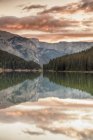 Sunrise over trees reflecting in water of Two Jack Lake, Banff National Park, Alberta, Canada — Stock Photo