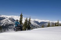 Single rider making way down slope while snowmobiling in Monashees, Thompson Okanagan, British Columbia, Canada — Stock Photo