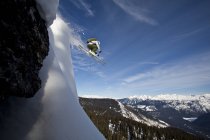 Male skier airing off snow pillow, Monashee Mountains, British Columbia, Canada — Stock Photo
