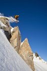 Male skier dropping off cliff in backcountry of Kicking Horse Resort, Golden, British Columbia, Canada — Stock Photo