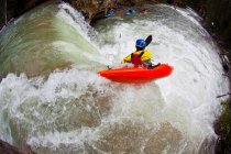 High angle view of male kayaker dropping waterfall on Johnston Canyon, Banff National Park, Canada — Stock Photo