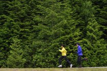 Coppia che corre sul sentiero intorno al lago Sasamat, Belcarra Regional Park, Port Moody, British Columbia, Canada — Foto stock