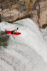 High angle view of male kayaker in mountain waterfall flow on Upper Elk River, Fernie, British Columbia, Canada — Stock Photo
