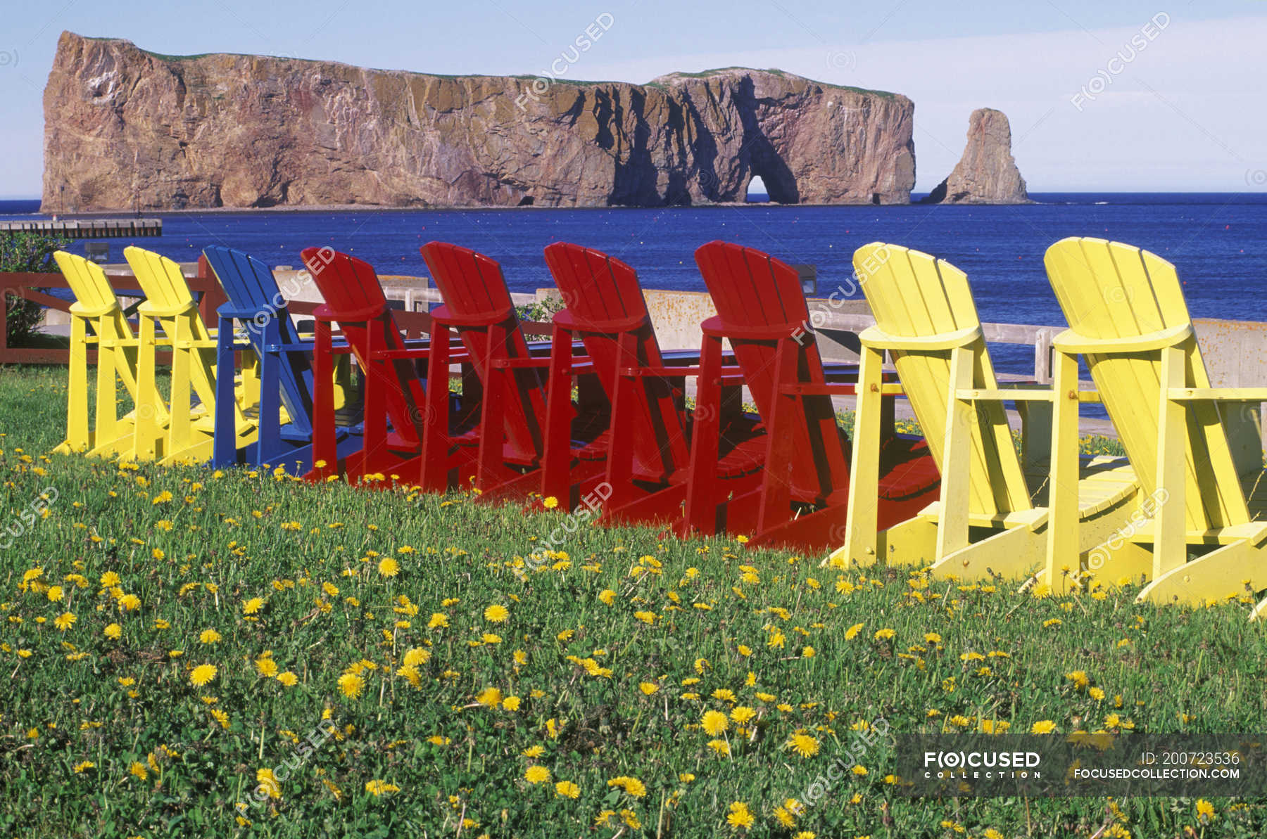 Perce Rock With Colorful Lawn Chairs Gaspe Peninsula Quebec