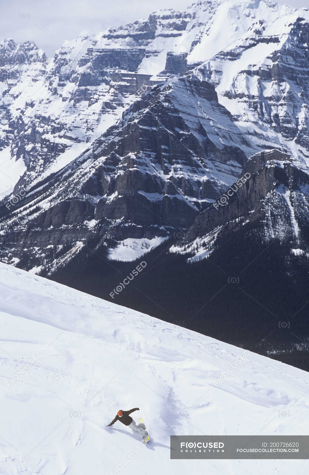 Man backcountry snowboarding at resort of Lake Louise, Alberta, Canada ...