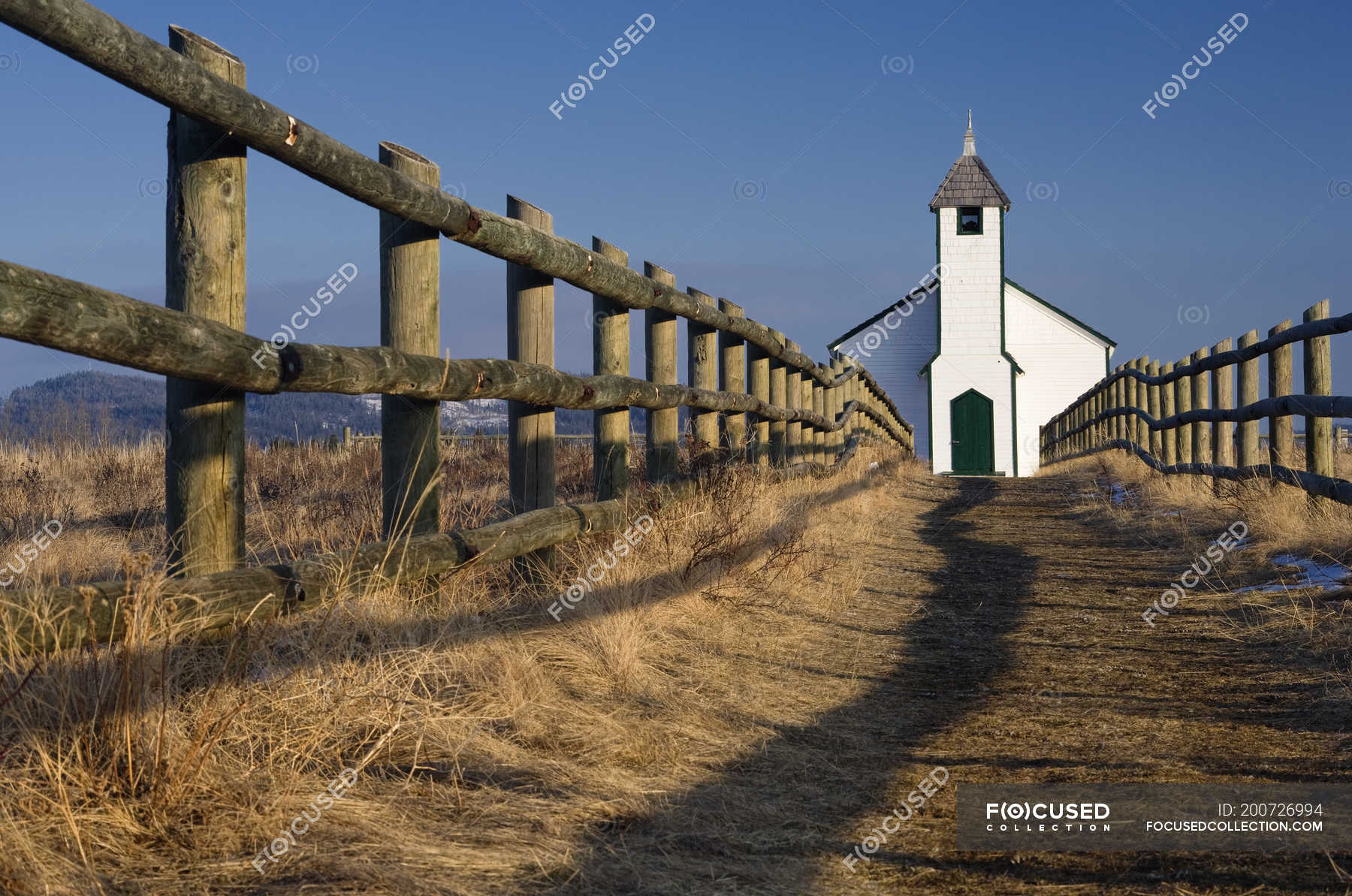 Low angle view of McDougal Church by end of wooden fence in Morley