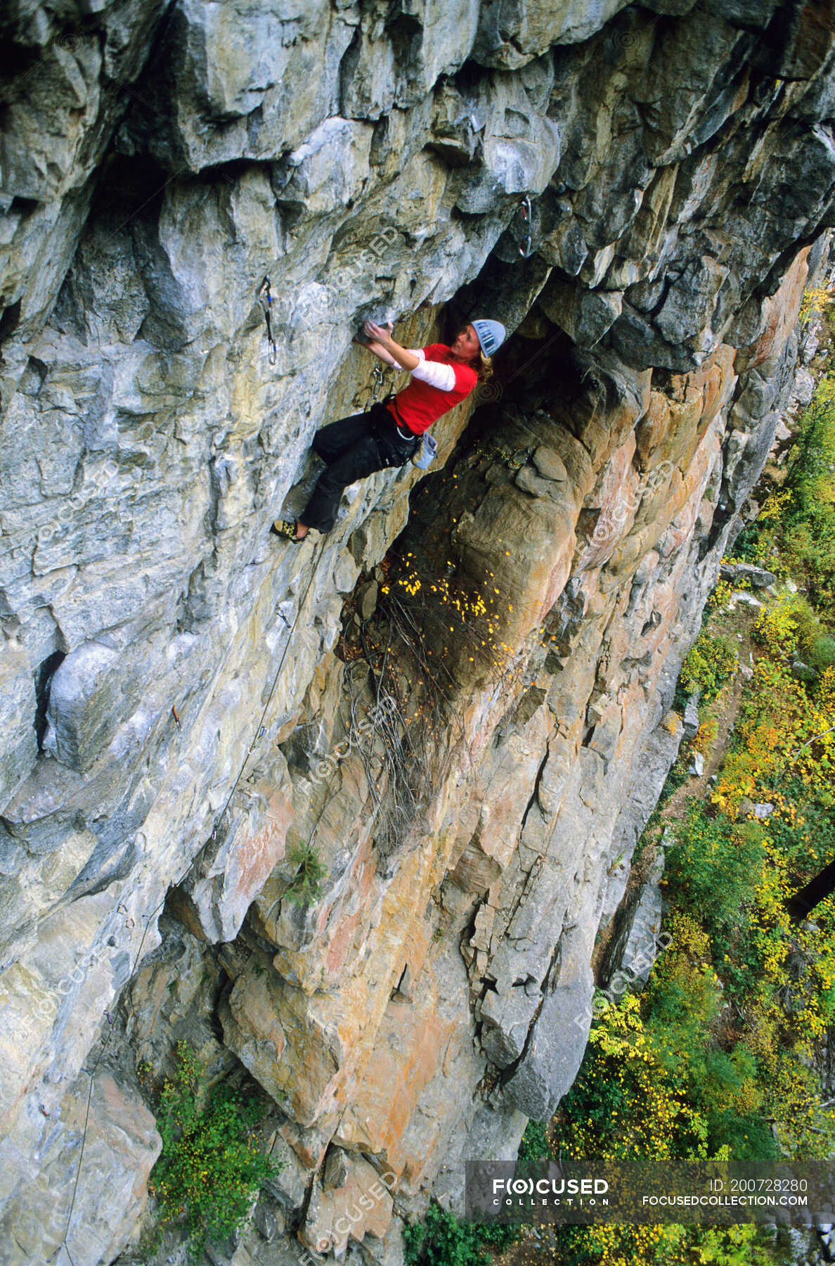 Woman climbing rock of Maternal Wall, Skaha Bluffs, Penticton, British