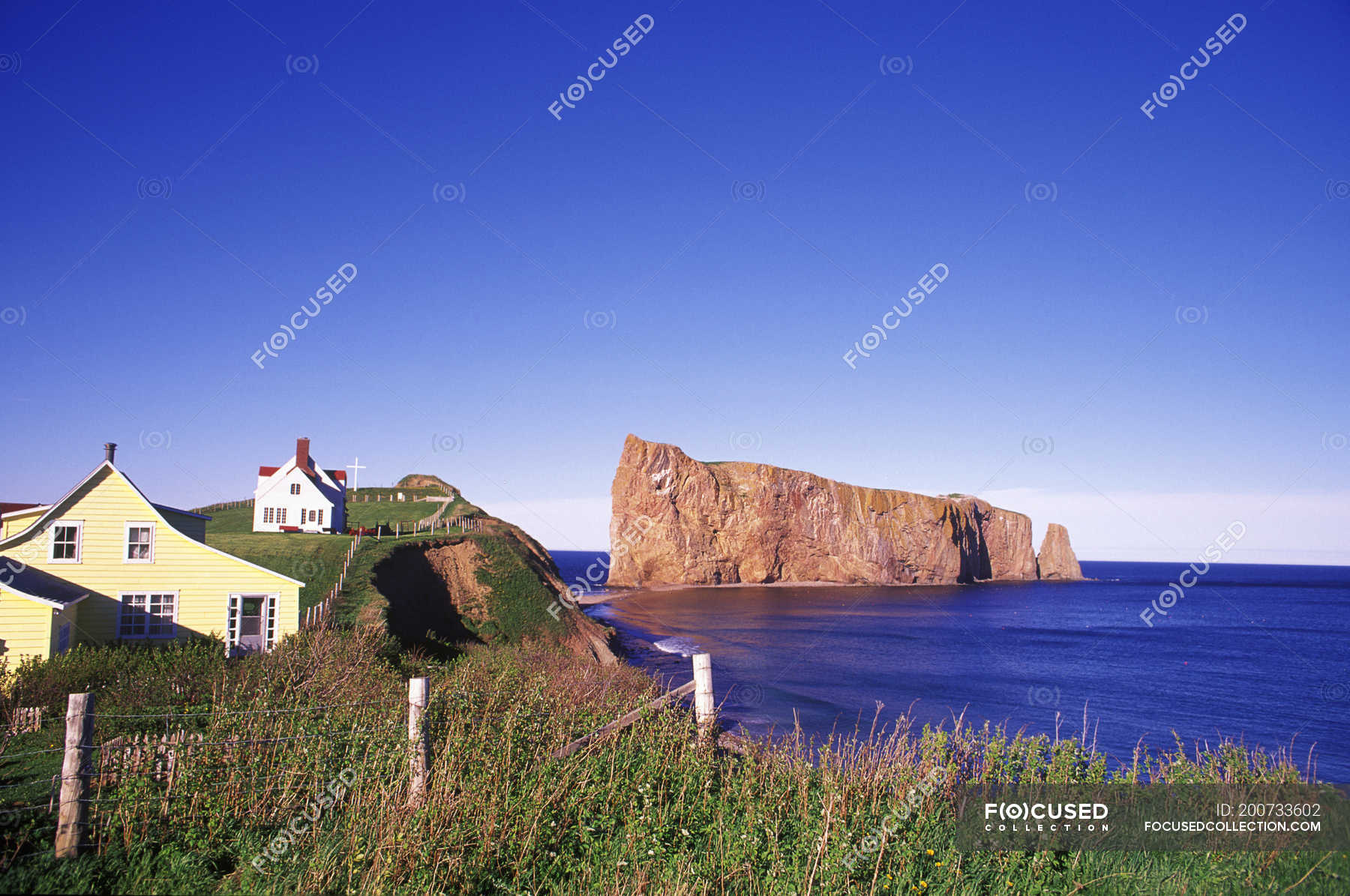 Perce Rock with village of Perce on Gaspe Peninsula, Quebec, Canada