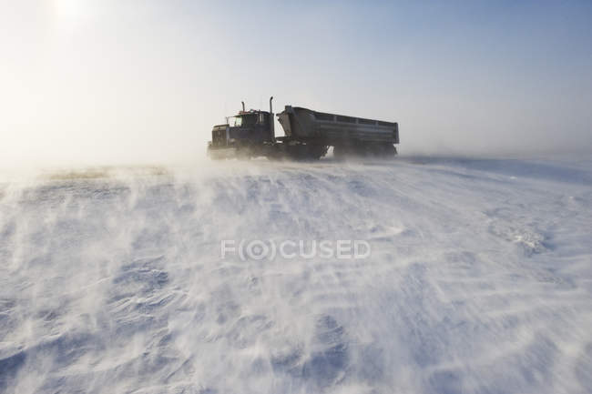 Truck vehicle on road covered with blowing snow near Morris, Manitoba, Canada — Stock Photo