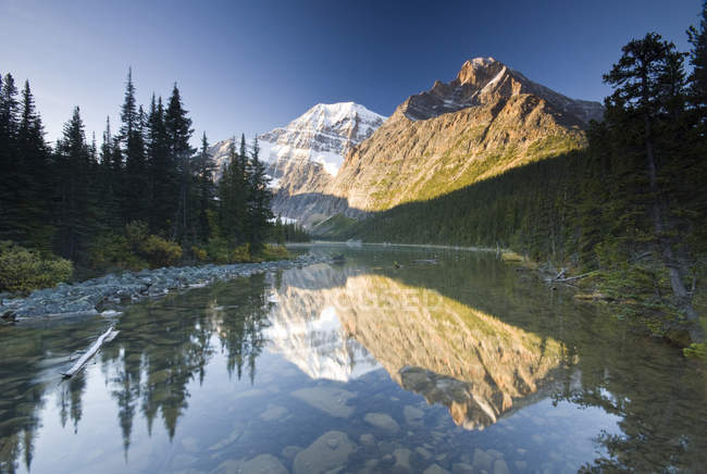 Mount Edith Cavell reflecting in Cavell Lake in Jasper National Park, Alberta, Canada. — Stock Photo