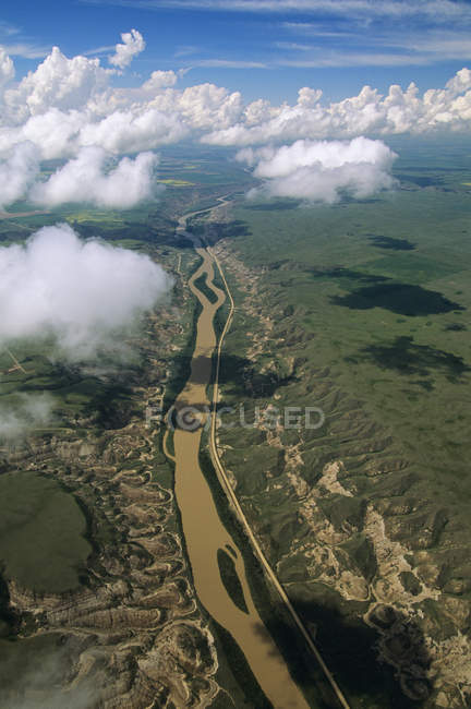 Aerial view of clouds in sky and badlands of Alberta, Canada. — Stock Photo