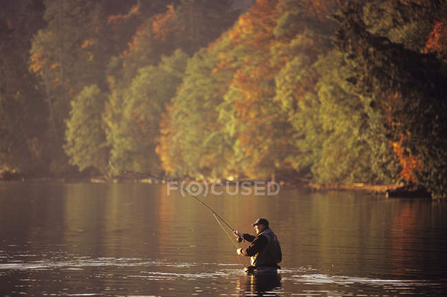 Man fly fishing in autumn, Cherry Point, Vancouver Island, British Columbia, Canada. — Stock Photo