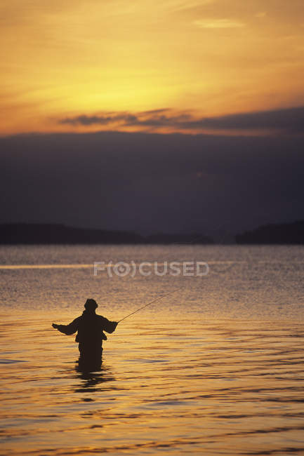 Silhouette of man fly-fishing at Cherry Point Beach, Cowichan Valley, Vancouver Island, British Columbia, Canada. — Stock Photo