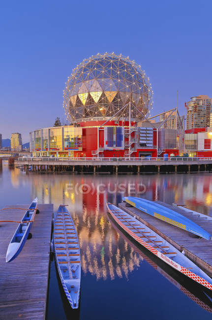 Telus World of Science reflecting in False Creek water with dragon boats, Vancouver, British Columbia, Canada — Stock Photo