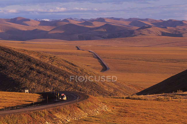 Truck riding on Dempster Highway by Richardson Mountains, Yukon, Canada. — Stock Photo