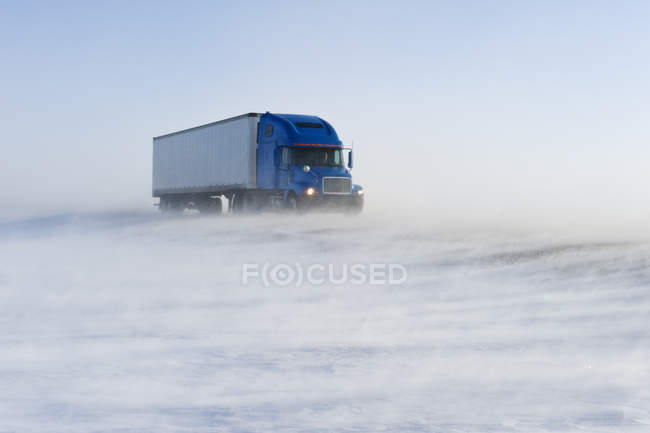 Truck vehicle on road covered with blowing snow near Morris, Manitoba, Canada — Stock Photo