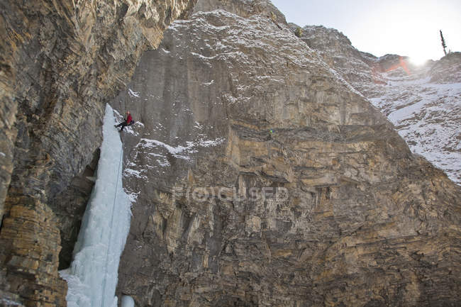 Man rappelling after free soloing at mountains of Ghost River Valley, Alberta, Canada — Stock Photo