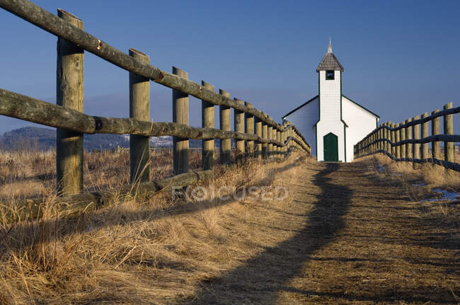 Low angle view of McDougal Church by end of wooden fence in Morley, Alberta, Canada — Stock Photo