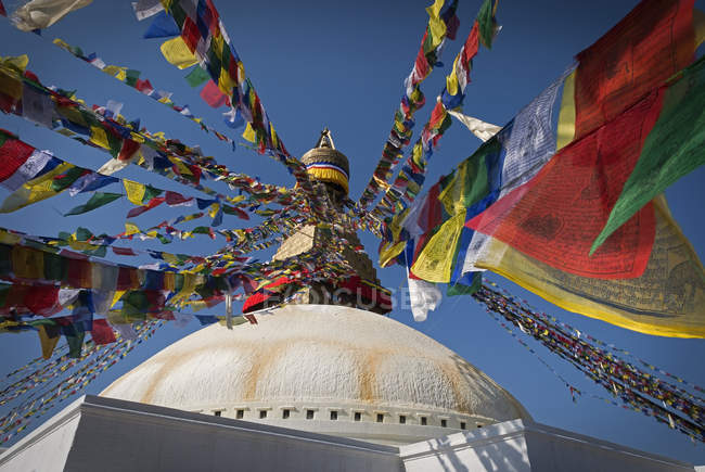 Low angle view of Boudhanath stupa with prayer flags at spiritual site in Kathmandu, Nepal. — Stock Photo